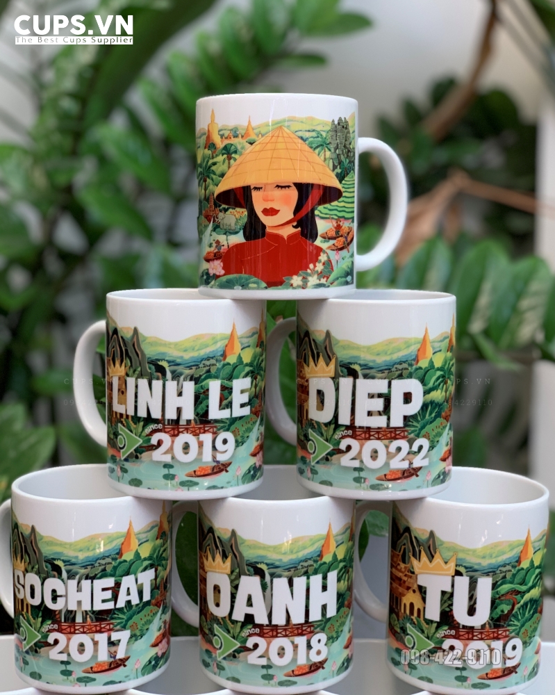 Close-up of personalized ceramic mug with employee name